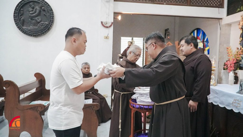 Friar Maximillian receiving his novitiate habit.