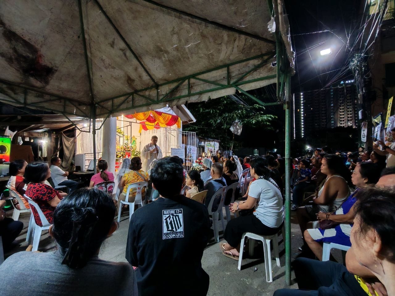Friar Jorgerson attending Mass celebrated on the street.
